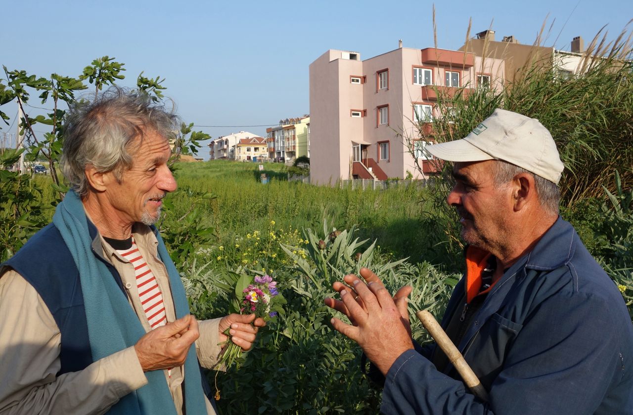 Turkey May 2013. The only common language is the sights and fragrances of the plants: Michel Fanton with a peasant in Cannakale.